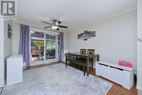 New Tecumseth (Alliston) apartment for rent - A living room with a sliding glass door and a ceiling fan.