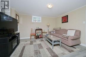 New Tecumseth (Alliston) apartment for rent - A living room with a couch, chair, and television.