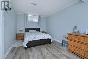 New Tecumseth (Alliston) apartment for rent - A bedroom with a bed, nightstand, and dresser.