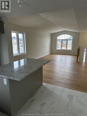Lakeshore apartment for rent - A large, empty room with a marble countertop and wooden flooring.
