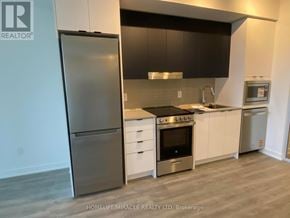Mississauga (Hurontario) condo for rent - A modern kitchen with a refrigerator, oven, and microwave.