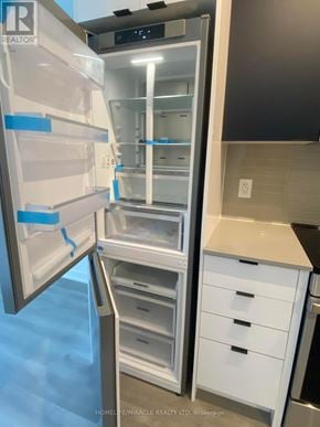 Mississauga (Hurontario) condo for rent - A refrigerator with its door open and shelves visible.