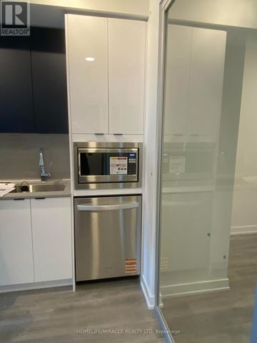 Mississauga (Hurontario) condo for rent - A modern kitchen with a stainless steel dishwasher and microwave.