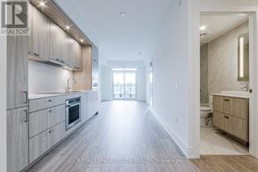 Toronto (Dovercourt-Wallace Emerson-Junction) condo for rent - A spacious kitchen with wooden cabinets and a large island.