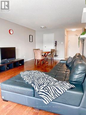 London North (North G) condo for rent - A living room with a grey couch and a television.