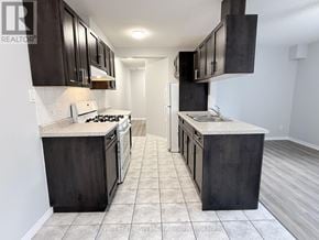 Guelph (Downtown) multi-family for rent - A kitchen with dark wood cabinets and a white stove top oven.