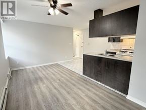 Guelph (Downtown) multi-family for rent - A room with a ceiling fan and a kitchenette.