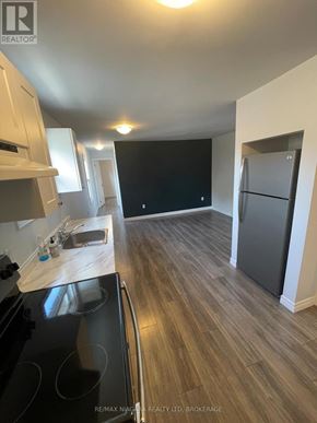 Welland (Lincoln/Crowland) apartment for rent - A kitchen with a black stove top oven and wooden flooring.