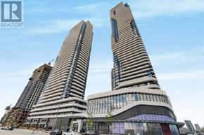 Vaughan (Vaughan Corporate Centre) condo for rent - Two tall buildings with striped facades are the main focus of the image.
