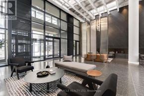 Vaughan (Vaughan Corporate Centre) condo for rent - A modern living room with a glass wall and a black and white rug.