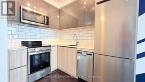 Toronto (Downsview-Roding-Cfb) condo for rent - A kitchen with a refrigerator, oven, and microwave.