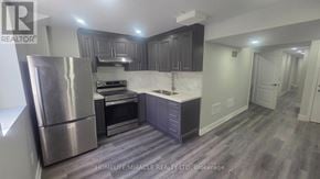 Brampton (Northwest Brampton) apartment for rent - A kitchen with a stainless steel refrigerator, oven, and cabinets.