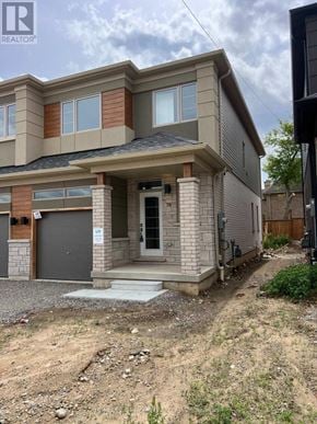 Brantford apartment for rent - A house under construction with a grey garage door.