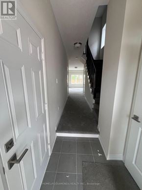 Brantford apartment for rent - A hallway with white doors and a tiled floor.