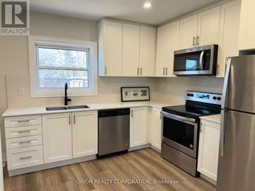 Mississauga (Lakeview) apartment for rent - A kitchen with white cabinets and stainless steel appliances.