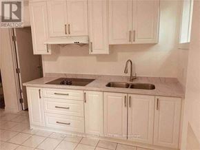 Toronto (Agincourt South-Malvern West) apartment for rent - A kitchen with white cabinets and a marble countertop.