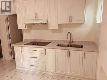 Toronto (Agincourt South-Malvern West) apartment for rent - A kitchen with white cabinets and a marble countertop.