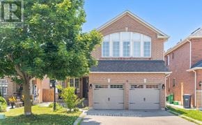 Brampton (Snelgrove) apartment for rent - A house with a large front yard and a tree in the foreground.