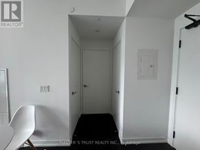 Toronto (Waterfront Communities) condo for rent - A white chair is in the corner of a room with white walls.