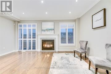 Oakville (Go Glenorchy) townhouse for rent - A living room with a fireplace and a painting on the wall.