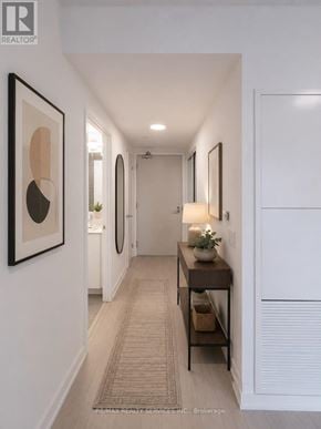 Toronto (Humber Heights) condo for rent - A hallway with a table and a plant on it.