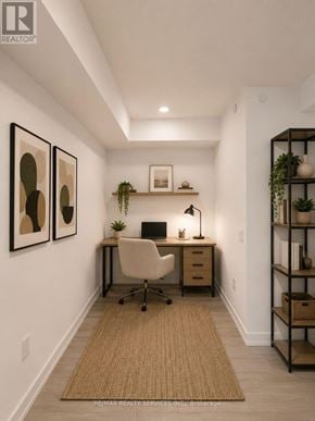 Toronto (Humber Heights) condo for rent - A well-lit home office with a desk, chair, and shelving unit.