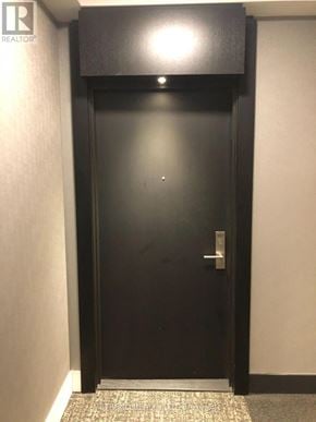 Toronto (Church-Yonge Corridor) condo for rent - A black door with a silver handle in a hallway.