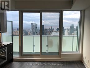Toronto (Church-Yonge Corridor) condo for rent - A balcony with glass doors overlooking a cityscape.