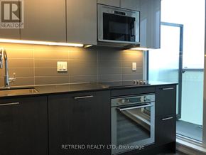 Toronto (Church-Yonge Corridor) condo for rent - A modern kitchen with a microwave oven mounted above the stove.