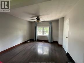 Chatham apartment for rent - A room with a ceiling fan and a window with curtains.