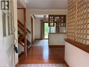 Ancaster apartment for rent - A hallway with a wooden floor and a white door.