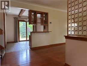 Ancaster apartment for rent - A room with wooden floors and a wall with a patterned design on the right side.