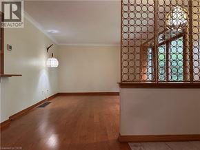 Ancaster apartment for rent - A room with wooden floors and a window with a lattice design.