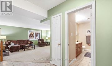 Guelph (Clairfields/Hanlon Business Park) apartment for rent - A living room with a couch and a chair.