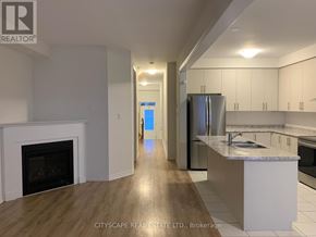 Centre Wellington (Fergus) apartment for rent - A kitchen with a fireplace and a refrigerator.