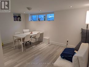 Toronto (Lansing-Westgate) apartment for rent - A white dining table with four chairs is in a room with a window.