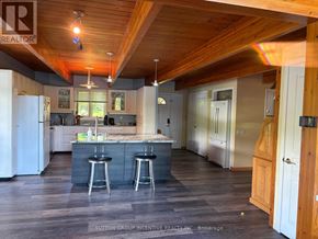 Gravenhurst (Wood (Gravenhurst)) apartment for rent - A kitchen with a bar and stools in the middle of the room.