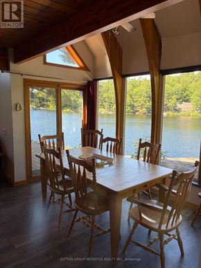 Gravenhurst (Wood (Gravenhurst)) apartment for rent - A dining room with a table and chairs overlooking a body of water.