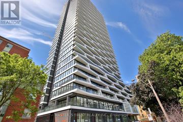Toronto (Church-Yonge Corridor) condo for rent - A tall building with the words "Masters Trust Realty Inc. Brokerage" on its facade.