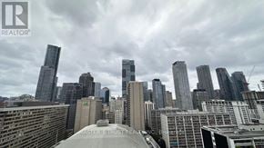 Toronto (Church-Yonge Corridor) condo for rent - A cityscape with a cloudy sky and a building in the foreground that says Master's Trust.