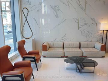 Toronto (Church-Yonge Corridor) condo for rent - A living room with a white sofa, orange chairs and a glass table.