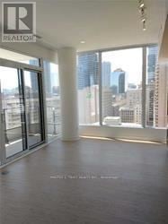 Toronto (Church-Yonge Corridor) condo for rent - A large empty room with a view of the city outside the windows.