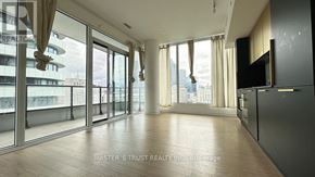 Toronto (Church-Yonge Corridor) condo for rent - A spacious room with a view of the city through large windows.