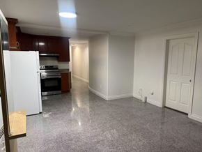 Surrey apartment for rent - A kitchen with white appliances and brown cabinets.