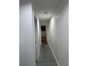 Surrey apartment for rent - A long hallway with a door at the end.