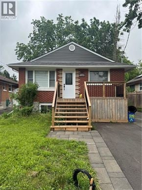 Kitchener apartment for rent - A house with a grey roof and a white door is for sale.