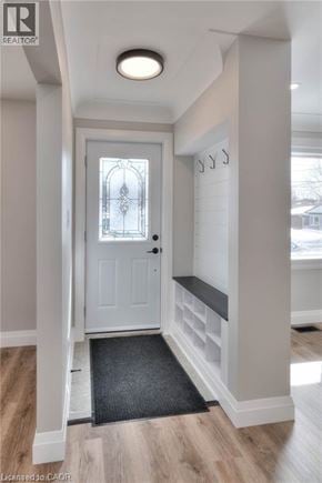 Kitchener apartment for rent - A white door with a glass window is in the middle of a hallway.