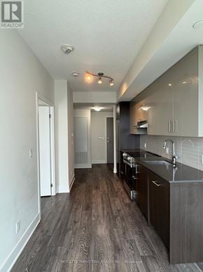 Toronto (Don Valley Village) condo for rent - A modern kitchen with dark wood floors and white walls.