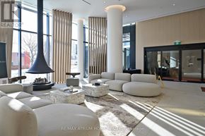 Mississauga (Mississauga Valleys) condo for rent - A modern living room with white furniture and a large window.