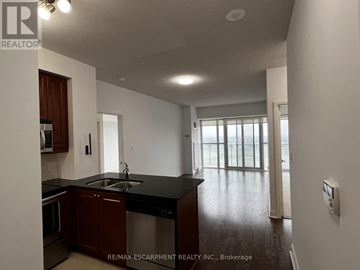 Mississauga (City Centre) condo for rent - A kitchen with a sink and a stove top oven.